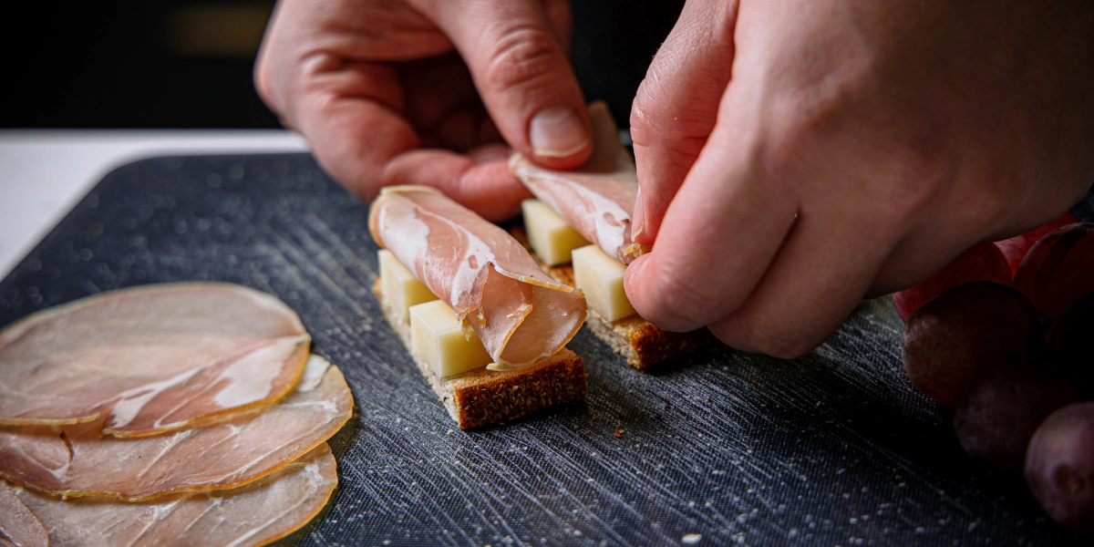 Нарежьте сыр на&nbsp;брусочки, а виноград на&nbsp;половинки